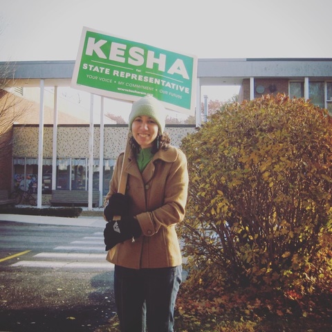 Kesha holding her campaign sign